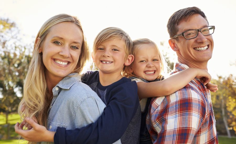 Oklahoma family smiling together in a park
